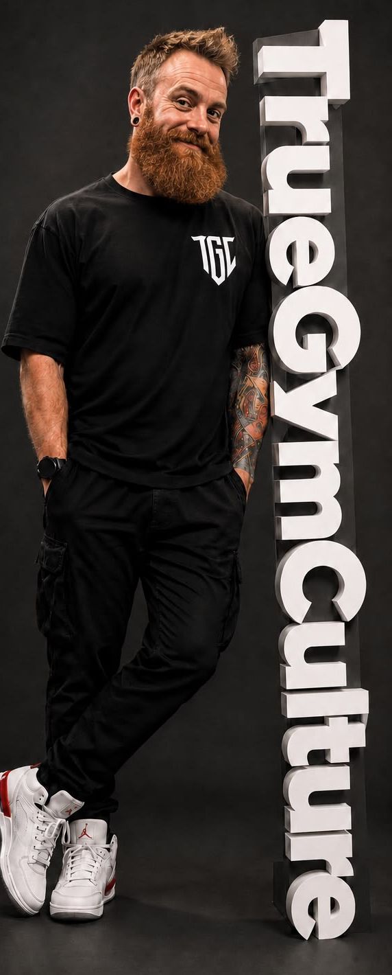 The founder of True Gym Culture leaning on a 3D True Gym Culture sign